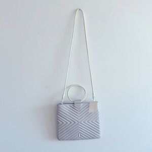 Thacker light grey leather , metal ring handles small bag.